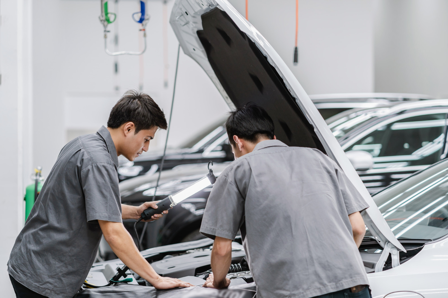 asian mechanics open car hood checking engine maintainance service center 1