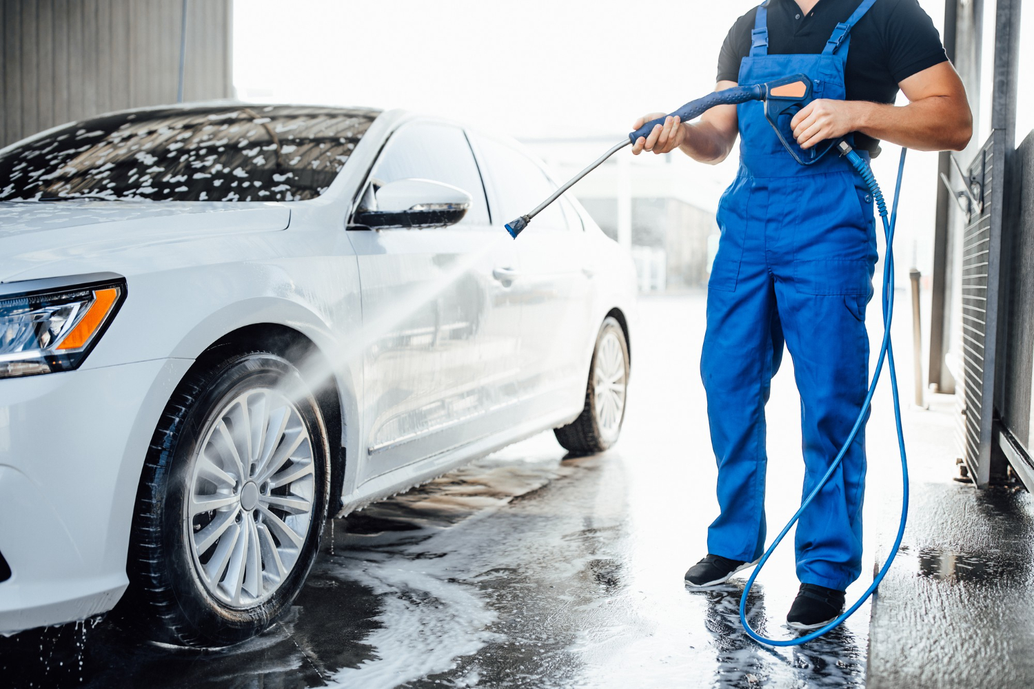 professional washer blue uniform washing luxury car with water gun open air car wash 1